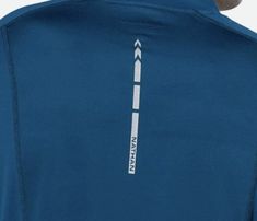 the back of a man's blue shirt with an arrow on it and white writing