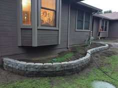 a house that has some grass in front of it and a fire hydrant on the side