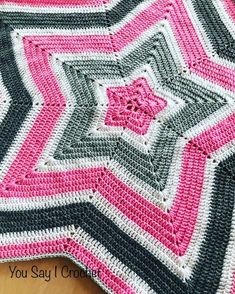 a crocheted blanket that is on top of a table