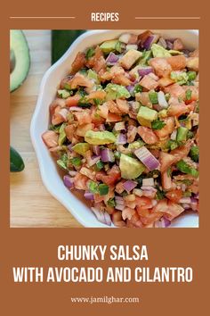 chunk salsa with avocado and cilantro in a white bowl on a wooden table