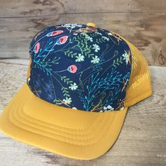 This floral design is always a good choice. Goes with everything. All hats have a terry cloth lining, mesh back, and snap adjustable back. We believe in individual expression, hand crafting, and getting outside. Our hats are meant to instill adventure in you whenever you wear them! All our hats are hand stitched by us, local women, or our team of lady stay at home mom seamstresses in L.A. Every hat is unique as they are not mass produced. We buy our fabrics from small fabric designers or work cl Spring Beach Trucker Hat, 5-panel, Spring Beach Snapback Hat, 5-panel, Adjustable Baseball Cap Trucker Hat For Festivals, Casual Floral Print Cap, Adjustable 5-panel Snapback Hat For Festivals, Adjustable 5-panel Baseball Cap For Festivals, Festival 5-panel Trucker Hat One Size, Adjustable 5-panel Festival Hat, Festival 5-panel Trucker Hat