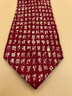 "This gorgeous red silk  tie is clean, fresh and ready to go! Make a statement with this unique tie featuring a series of Chinese Mandarin characters. Beautiful shiny red silk background with beige Mandarin letters. The tie is in excellent condition, clean and ready to wear. 100% silk and looks like it has never been worn.  The widest measurement is 3 3/4\". The designer is Gold City, Hand Made. (SHOPTIERACKFILE5)" Red Standard Tie For Formal Occasions, Classic Silk Ties As Gift, Silk Standard Tie As A Gift, Classic Red Neckwear Perfect For Gifts, Elegant Red Neckwear For Gift, Elegant Red Neckwear As A Gift, Red Standard Tie As Gift, Silk Standard Tie As Gift, Red Standard Tie As A Gift