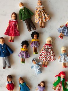 many dolls are arranged on a marble surface