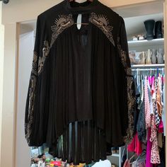 It Has Beadwork From The Shoulders All The Way Down To The Bottom Of The Sleeve. It Has A Peek Hole On The Chest And It Buttons Around The Back Of The Neck. Embroidered Long Sleeve Blouse For Night Out, Bohemian Black Tops With Embroidered Neckline, Bohemian Long Sleeve Blouse For Night Out, Fall Bohemian Black Embroidered Top, Bohemian Embellished Tops For Fall, Chic Black Embellished Blouse, Bohemian Long Sleeve Blouse For Evening, Bohemian Long Sleeve Evening Blouse, Elegant Fall Festival Tops