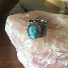 A Stunning Artisan Ring With 14k Yellow Gold Bezel, Sterling Silver Etched Thick Band And A Stunning Labradorite Center Faceted Stone. Size 7. Face Of Stone Is 1/2”. I Don’t See A Stamp. Artisan Rings, Womens Jewelry Rings, Sterling Ring, Labradorite, Silver Gold, Yellow Gold, Size 7, Women Jewelry, Stamp