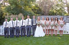 a group of people standing next to each other in front of a white picket fence