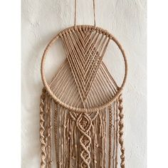 a macrame dream catcher hanging on a wall