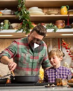 a man and his son cooking in the kitchen