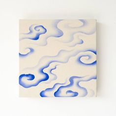 a painting on a white wall with blue swirls in the center and bottom half