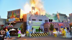 the sesame street movie theater is on fire with people standing around and watching it burn