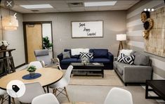 a living room with couches, chairs, tables and pictures hanging on the wall