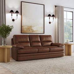 a living room scene with focus on the leather sofa and coffee table in the foreground