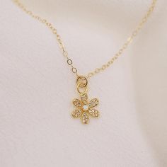 The sweetest daisy charm hangs along a delicate gold chain. It's petals are adorned with tiny cz's and a center opal stone. DETAILS: 14kt gold filled chain opal and cz accents choose length model wearing 17 inches long Dainty 14k Gold Charm Necklace With Flower Charm, Dainty 14k Gold-filled Flower Charm Necklaces, Dainty 14k Gold-filled Charm Necklaces With Flower Charm, Gold Dainty Opal Charm Necklace, Dainty Gold Opal Charm Necklace, Dainty 14k Gold Filled Charm Necklaces, Dainty Tiny Charm Necklaces Gold Plated, Dainty Flower Charm Necklaces, Delicate Gold Chain