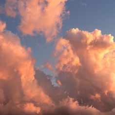 the sky is filled with pink clouds as the sun sets