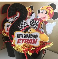 mickey mouse birthday centerpieces in a bucket with streamers