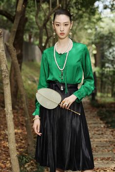 Upgrade your wardrobe with this stylish Green Silk Blouse and Black Skirt Set! Exuding to modern Chinese fashion, this outfit features an elegant green silk blouse with a black skirt for a look sure to draw attention. Buy now and look your best! Peak lapels; front button blazer V-Neck, Long sleeves; Structured shoulders. Blazer and Pant POLYESTER 14% Acetate 86%Silk 100% Brand - FUYAOZHISHANG Model Number - FYB174, FYS145 NOTE: The blouse is loose fit Transitional Green Art Silk Blouse Piece, Luxury Classic Green Blouse, Luxury Green Silk Skirt, Modern Chinese Fashion, Luxury Green Satin Blouse, Green Silk Blouse With Button Closure, Modern Chinese, Blazer Buttons, Green Silk