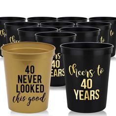 black and gold plastic cups with cheers to 40 years printed on the side, in different sizes