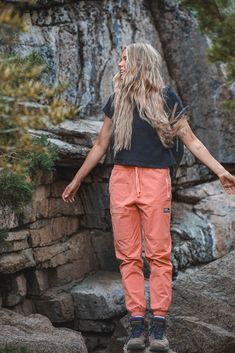 a woman standing on top of a rock formation