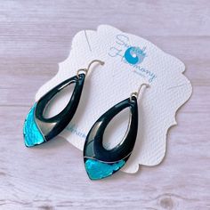 These earrings go from casual to classy with a quick outfit change. Black enamel contrasts with silver foil and aqua transparent enamel. I love how the aqua shines over the silver foil circles. The backs of the earrings are a medium blue unless you request otherwise. I make the ear wires from sterling silver. length of earring: 1 5/8" width at widest point: 3/4" drop from ear: 2 1/8" to bottom tip of earring Trendy Blue Teardrop Earrings For Gifting, Trendy Blue Teardrop Earrings Gift, Trendy Blue Teardrop Earrings For Gift, Quick Outfits, Silver Foil, Black Enamel, Teardrop Earrings, Ear Wires, Medium Blue