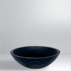 a black bowl sitting on top of a white table