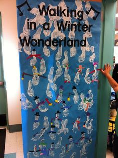 a person standing in front of a bulletin board with writing on it that says walking in a winter wonderland