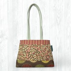 This medium, hand-sewn Pink & Brown Tote Bag is perfect for carrying your items to school, work, church, shopping, or travel. It also makes a great gift! ★ Features: * One-of-a-Kind: Personally handsewn by me using carefully selected fabrics, ensuring that you'll carry a truly unique, one-of-one piece. * Convenient Design: With no zippers or snaps, this tote bag is easy to throw on and go! * Travel-Friendly: Collapsible design allows for travel and saving space. * Eco-Friendly: Made from upcycled fabrics, this tote is a sustainable choice for the environmentally conscious. * Stylish and Durable: Fully lined with coordinating fabric for added durability and a polished look. ★ Details: * Size: 10.25" height x 14.5" width x 4.25" deep x 28.5" strap length * Pockets: 3 interior pockets * Prima Medium Travel Satchel, Rectangular Green Diaper Bag For Everyday Use, Green Rectangular Diaper Bag For On-the-go, Vintage Green Bag For Everyday Use, Vintage Green Bags For Everyday Use, Green Tote Diaper Bag For Everyday Use, Green Tote Diaper Bag For Daily Use, Everyday Green Tote Diaper Bag, Green Rectangular Diaper Bag With Removable Pouch