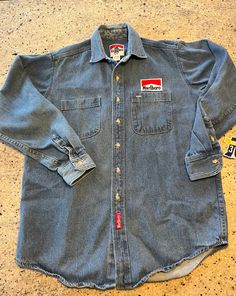 Vintage Marlboro Denim Shirt Button Up  Size Medium See pics for measurements  Long Sleeve Nice naturally slightly faded  Rare version that's Made in USA   Patches on both front and back.  This is also a thicker, heavier denim than other similar denim Marlboro shirts.  We have other sizes also - see our other listings - search Marlboro  Quick shipping We ship same or next day with USPS MAIL  We are a small family business and we appreciate your purchase, Godspeed ! Vintage Medium Wash Pre-washed Tops, Vintage Dark Wash Shirt With Pockets, Vintage Washed Denim Shirt, Vintage Medium Wash Washed Shirt, Vintage Medium Wash Shirt With Button Closure, Vintage Denim Shirt With Button Closure, Vintage Medium Wash Shirt With Pockets, Vintage Denim Shirt With Pockets, Vintage Light Wash Denim Shirt