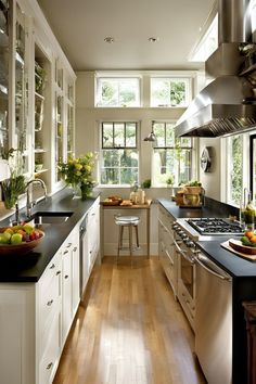 a kitchen filled with lots of counter top space next to a stove top oven and sink