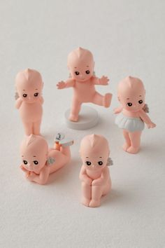 small figurines of babies on a white surface