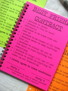 three notebooks with the words best friend contract written on them next to a pen