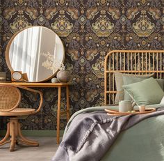 a bedroom with green wallpaper and a bed in the foreground is a mirror