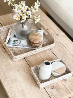 two trays with flowers and cookies on them sitting on a table next to each other