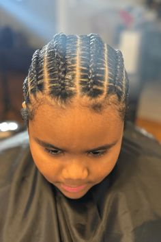 This hairstyle features smooth and evenly spaced cornrows that start at the forehead and go straight back to the neck, giving a tidy and standard look. The braids are done firmly to make sure they last a long time and stay neat, perfect for energetic kids who need a style that will endure. This cornrow hairstyle is not - Click to see more of 20 Cute Cornrow Styles for Little Ones: Hairstyle Inspiration for Kids and follow us for more hairstyle ideas. // Photo Credit: Instagram @catch.dees.handz Hairstyle Inspiration