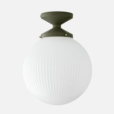 a white ball hanging from the ceiling with an olive green metal hook on it's end