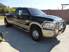 a large black truck parked in a driveway