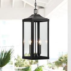 an outdoor hanging light fixture with three lights