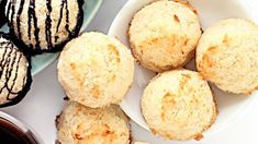 several different types of pastries in bowls next to each other on a white surface