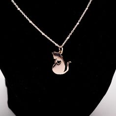 A great gift for the cat lover in your life! This necklace from Elizabeth Jewelry includes a sterling silver cat pendant with a heart cutout. Made in Oregon. Mother's Day Jewelry With Cat Design For Gift, Rose Gold Cat Design Jewelry For Gift, Rose Gold Cat Design Jewelry Gift, Silver Cat Design Jewelry For Mother's Day, Cat Print Jewelry Gift, Silver Heart-shaped Cat Design Jewelry, Cat Design Pendant Charm Necklaces For Gift, Cat With Heart, Silver Cat Pendant