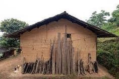 an old building with sticks sticking out of it's roof