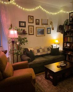 a living room filled with furniture and lots of pictures hanging on the wall above it