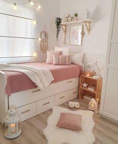 a bedroom with white walls and pink bedding