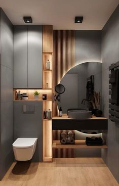 a bathroom with a toilet, sink and wooden shelves in it's center area