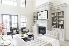 a living room filled with furniture and a fire place in the middle of a room