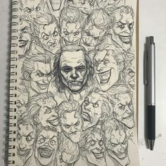 a notebook with a drawing of many faces on it