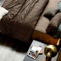 a leopard print comforter on top of a bed