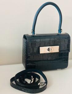 The Blue leather handbag is a stylish blend of sophistication and glamour. It is crafted with genuine leather with attention to details. Dimensions: (LxW): 7.09 inches x 2.76 inches x 5.51 inches Material: 100% Leather Features: Lock closure, Detachable leather strap Estimated Delivery: 3-4 Days High-end Blue Crossbody Shoulder Bag, High-end Blue Shoulder Bag With Detachable Strap, High-end Blue Satchel Shoulder Bag, High-end Blue Shoulder Bag Satchel, High-end Blue Shoulder Satchel, High-end Blue Box Bag For Everyday Use, High-end Blue Box Bag For Daily Use, High-end Blue Box Bag For Shopping, High-end Blue Top Handle Box Bag