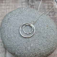 STERLING SILVER 2 CIRCLE NECKLACE This lovely necklace is hand made from 2 circles of Sterling Silver.  The largest circle has a smooth finish and measures approximately 20 mm in diameter, the smaller twisted circle measures approximately 12 mm in diameter.  This necklace can be finished with either a 16, 18 or 20 Inch cable chain.  Please note: This item is made to order.  Packaging: Your item will be wrapped in tissue paper, placed in a branded Jewellery by Jo Gift box or bag and packaged in a Holy Jewelry, Double Circle Necklace, Twisted Necklace, Silver Jewelry Design, Necklace Ring, Initial Pendant Necklace, Formal Outfits, Silver Circle, Lovely Necklace