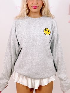 Add a smile to your wardrobe with the Happy Heart Crewneck from Sassy Shortcake - This grey crewneck features a smiley face with heart eyes. Also available in a tee version. fit: true to size, model wearing a size small. care: hand wash cold Cute Crew Neck Sweatshirt For Everyday, Trendy Gray Crew Neck Sweatshirt, Trendy Fall Sweatshirt With Smiley Face, Trendy Smiley Face Sweatshirt For Fall, Cute Gray Crew Neck Top, Trendy Fall Tops With Smiley Face, Gray Crew Neck Cute Tops, Trendy Smiley Face Tops For Fall, Trendy Fall Smiley Face Tops