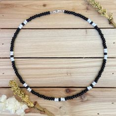 The Black & White beaded choker can go with any outfit. Whether you are out at dinner or a party on the beach, this choker is just what you need! All chokers are customizable to the size you need so please be sure to measure your neck where you want your choker to sit and order accordingly! This Seed Bead Necklace For Men, Black Beaded Necklaces With Spacer Beads For Beach, Black Beaded Necklaces For Beach, Summer Beaded Necklace With Black Round Beads, Black Heishi Beads For Beach, Summer Black Beaded Round Necklaces, Black Beaded Necklace For Beach With Tiny Beads, Beach Black Beaded Necklace With Tiny Beads, Black Wooden Beads For Beach