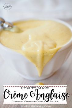 a white bowl filled with cream sauce on top of a wooden table